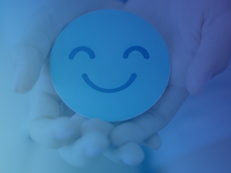 Hands holding a smiley face representing caring for your mental health