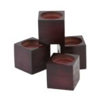 A set of Drive 3'' Wooden Chair Raisers. Three of the blocks are sitting below with one stacked on top. On a white background.