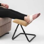 Drive Adjustable Footstool being used by a person with their legs upon the Footstool white sitting in a riser recliner chair.