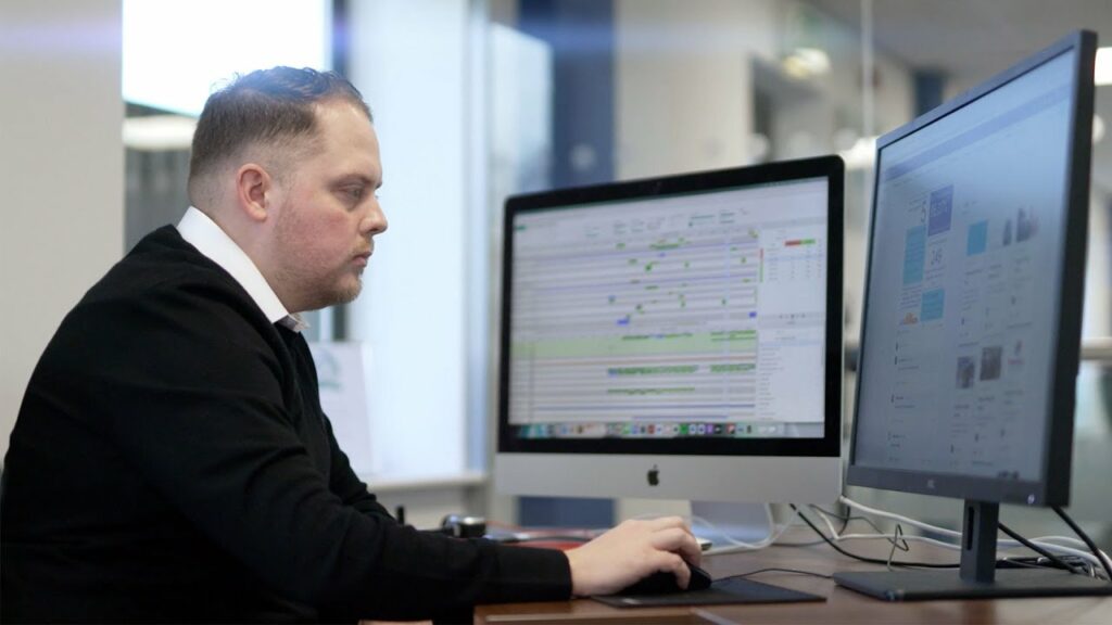 Care Digitisation Journey image with Premier Community's CEO Dan Isterling at a computer