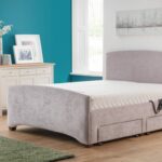 Elegant bedroom with a teal accent wall features a plush gray Custom Retford Double bed with storage drawers, natural light streaming through large windows, and a cozy, modern vibe.