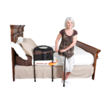 Woman getting up from a bed using a Stander Mobility Bed Rail