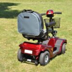 Splash Slipover Scooter Bag on a mobility scooter sitting on grass.