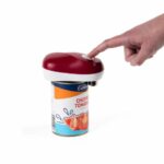 Drive Automatic Can Opener sitting on top of a tin of tomatoes, with someone's finger pressing the top button.