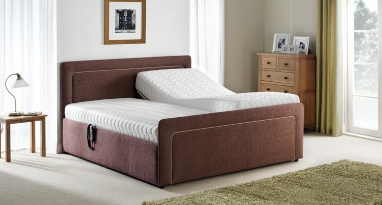 Modern bedroom with a brown adjustable bed, one side elevated. Soft lighting, a wooden nightstand, and a dresser create a cozy and serene atmosphere.