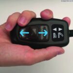 Uplift Powered Lifting Cushion Controller within someone's hand.