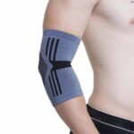 A wearing a Kedley Active Elasticated Elbow Support on his right elbow on a white background.