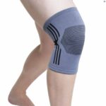 A persons leg wearing a grey Kedley Active Elasticated Knee Support bent forward slightly towards the camera.