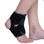 Kedley Advanced Ankle Support on a persons ankle on a white background.