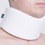 A man wearing the Kedley Orthopaedic Support Neck Collar