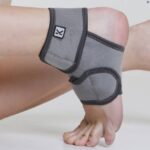 A model's foot wearing Kedley Pro-Light Neoprene Ankle Support.