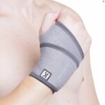 The Kedley Pro-Light Neoprene Wrist Support on a topless male's wrist on a white background.
