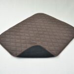 Vida Washable Chair Pads Brown with a corner turned up, the underneath is black, sitting on a white background.