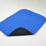 Vida Washable Chair Pads Blue turned up at one corner showing a black underneath, on a white background.