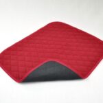 Vida Washable Chair Pads Red sitting on a white background, with one corner turned up showing the black underneath.