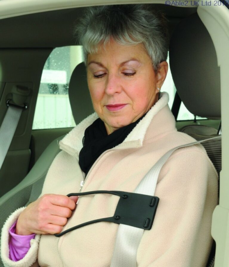 A woman sitting in a car holding onto the Seat Belt Reacher
