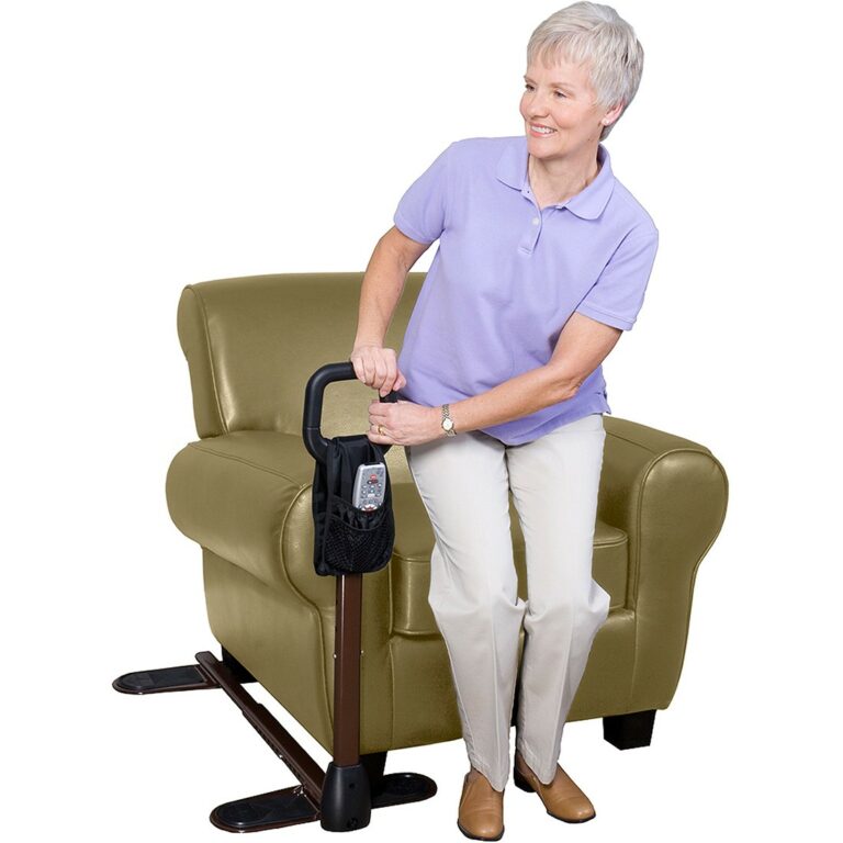 A woman leaning on a Stander Couch Cane standing up from a chair.