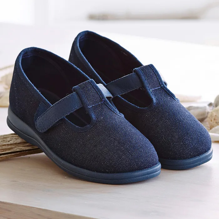 A pair of Cosyfeet Steffi Dark Denim sitting on wood.