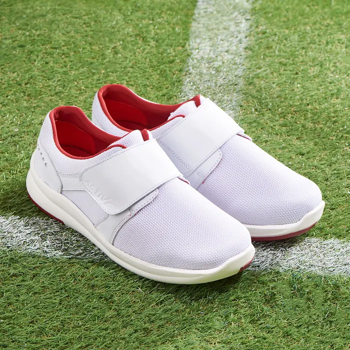 Cosyfeet Victor White sitting on a white line of football pitch