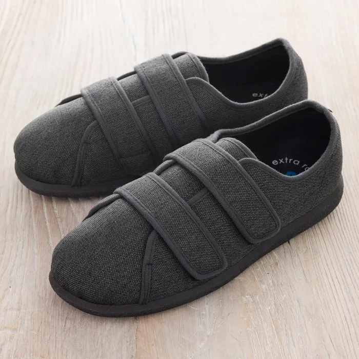 Cosyfeet Steven in Charcoal grey on a pale wooden floor.