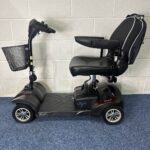 a black scooter with basket on wheels