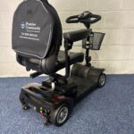 a black scooter with a basket on it