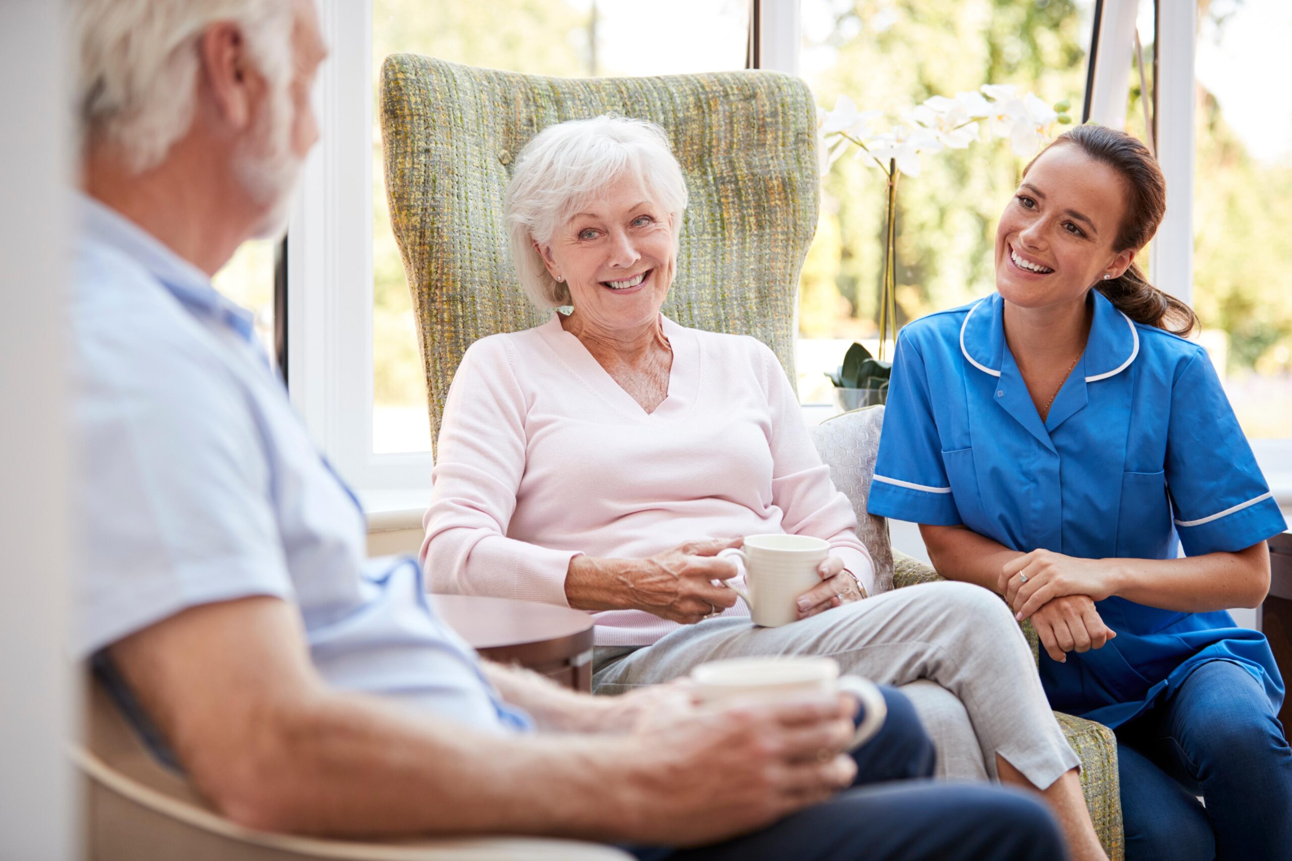 Carer speaking to an elderly couple discussing home care in Ilkeston