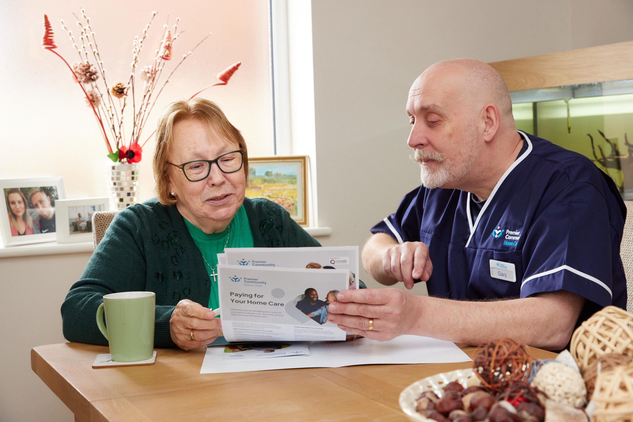 Premier Community Carer reading through documents with a service user