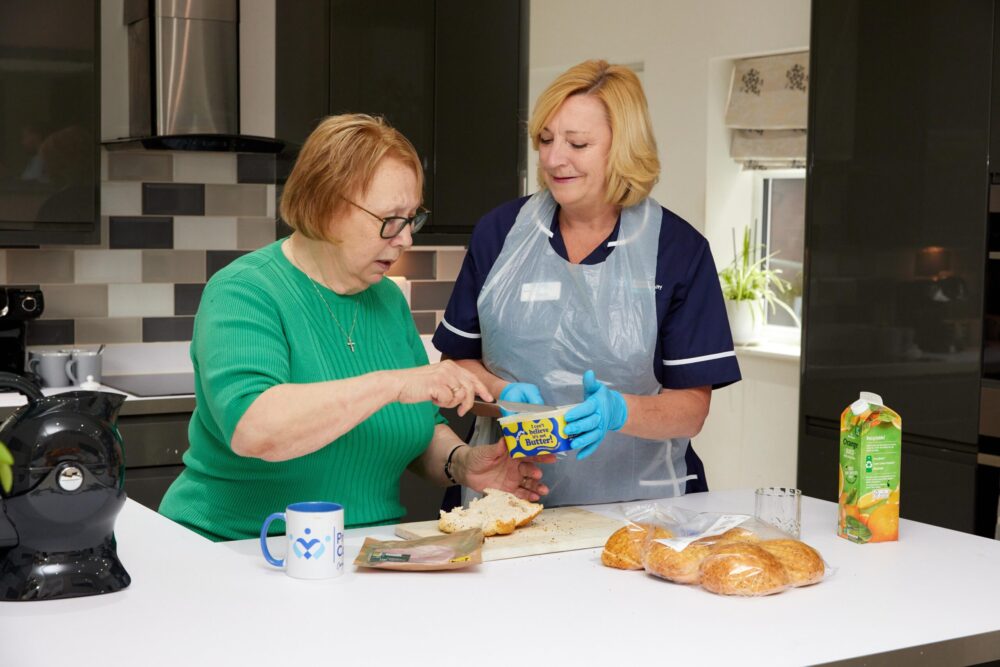 Premier Community Carer supporting a service user with food preparation during a home help visit