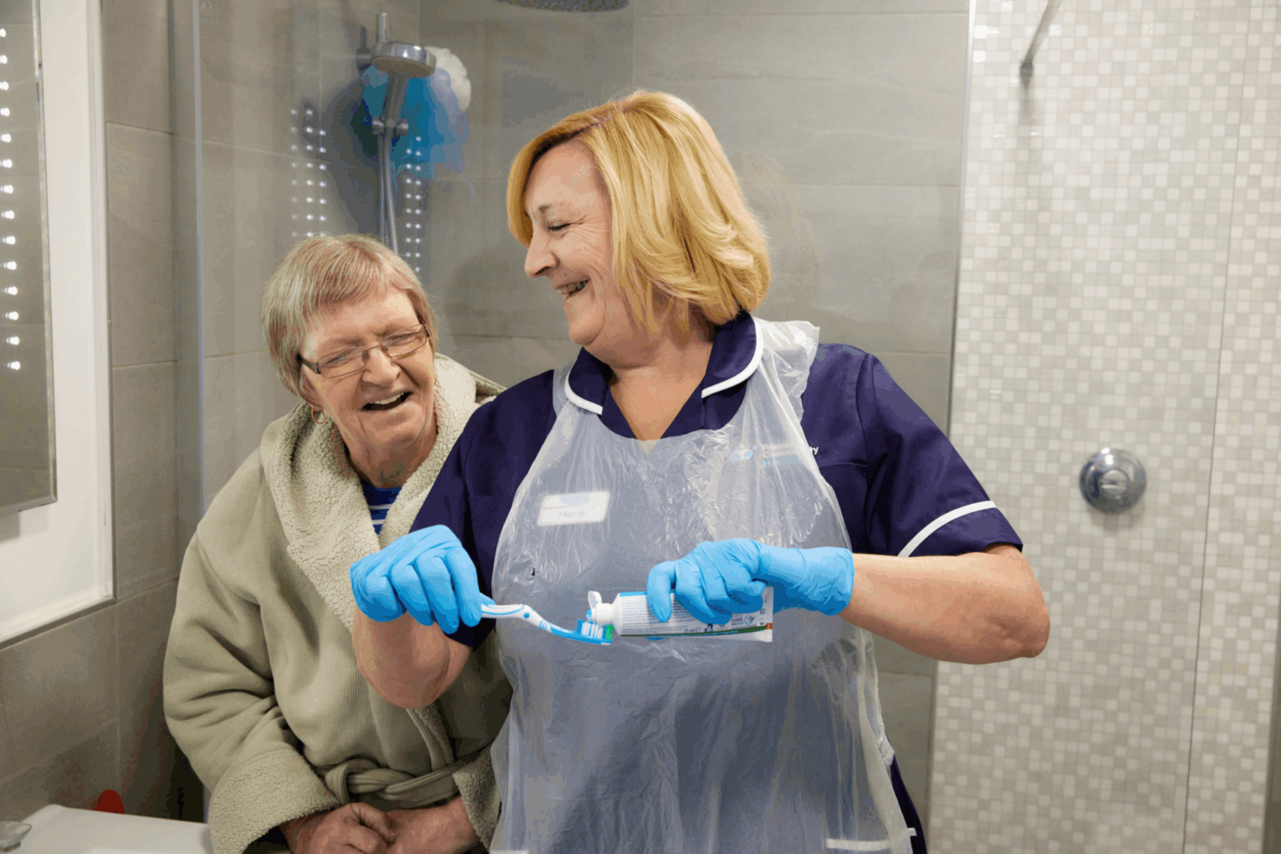 Premier Community Carer assisting a service user with brushing their teeth supporting live-in care