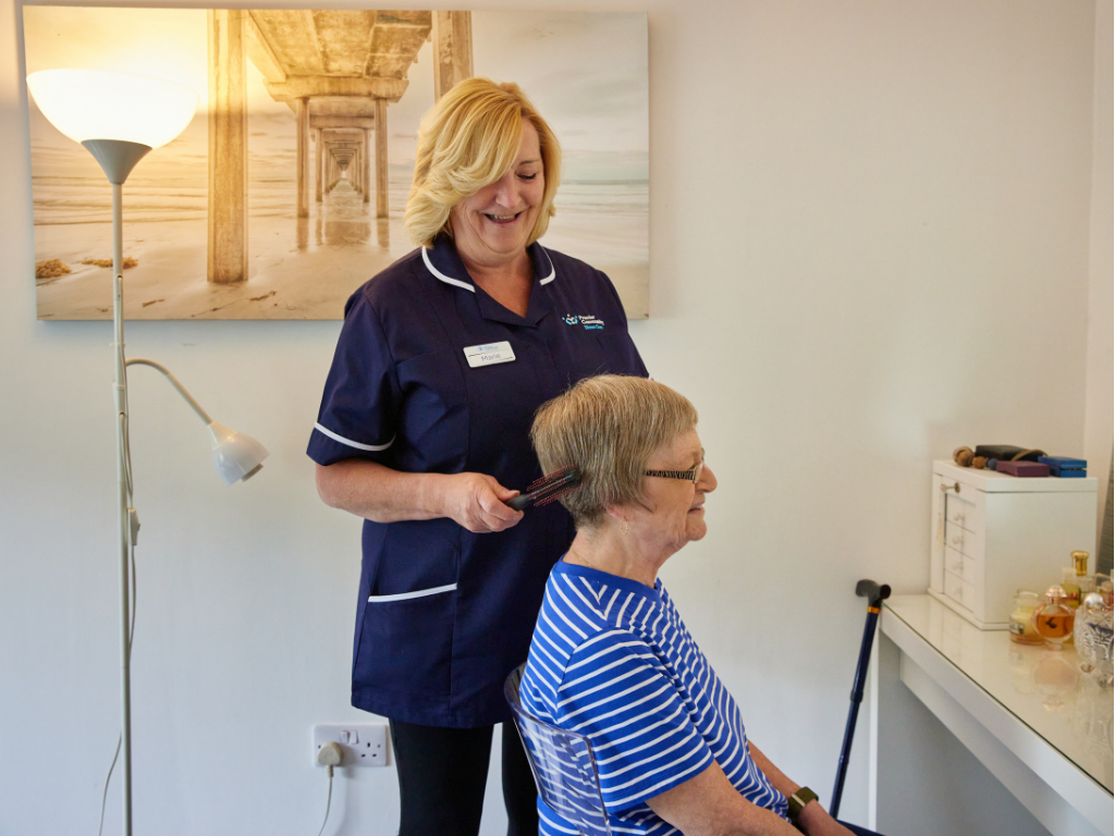 Care Giver brushing service users hair