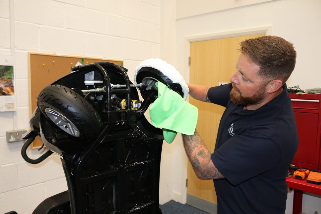 Engineer cleaning scooter