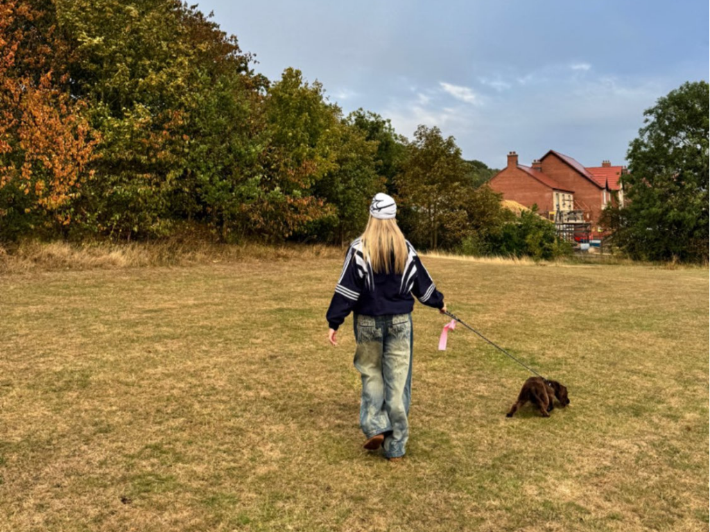 Alyssa waling a god in a field for cancer research