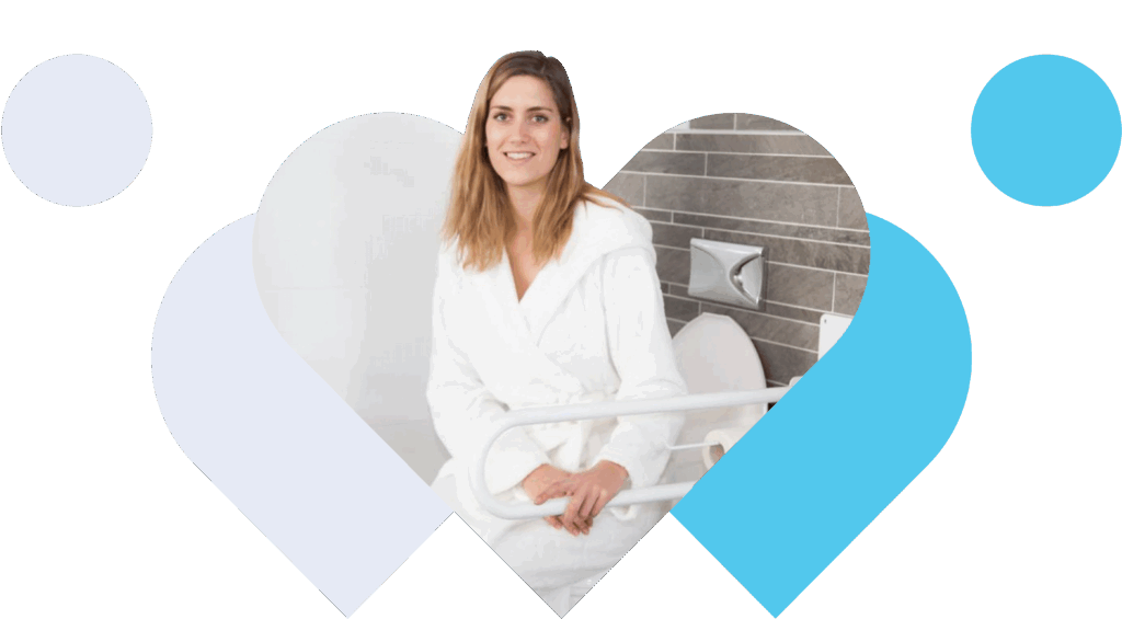 Woman in a dressing gown, sitting on a toilet holding a grab rail.