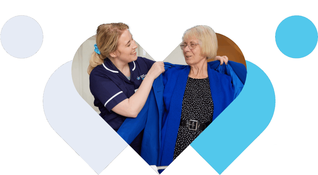 Carer helping someone place their coat on.