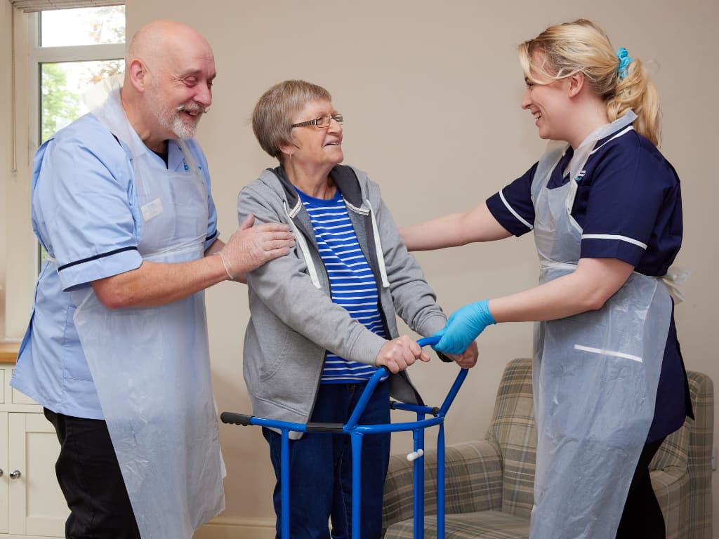 One of Premier Community's Lead Community Carer's Gary Hunt, supporting a colleague and a service user