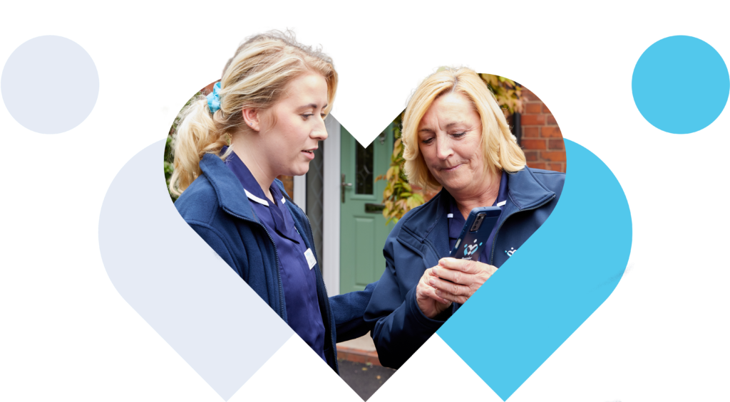 Two home care workers using a mobile app during a home care visit