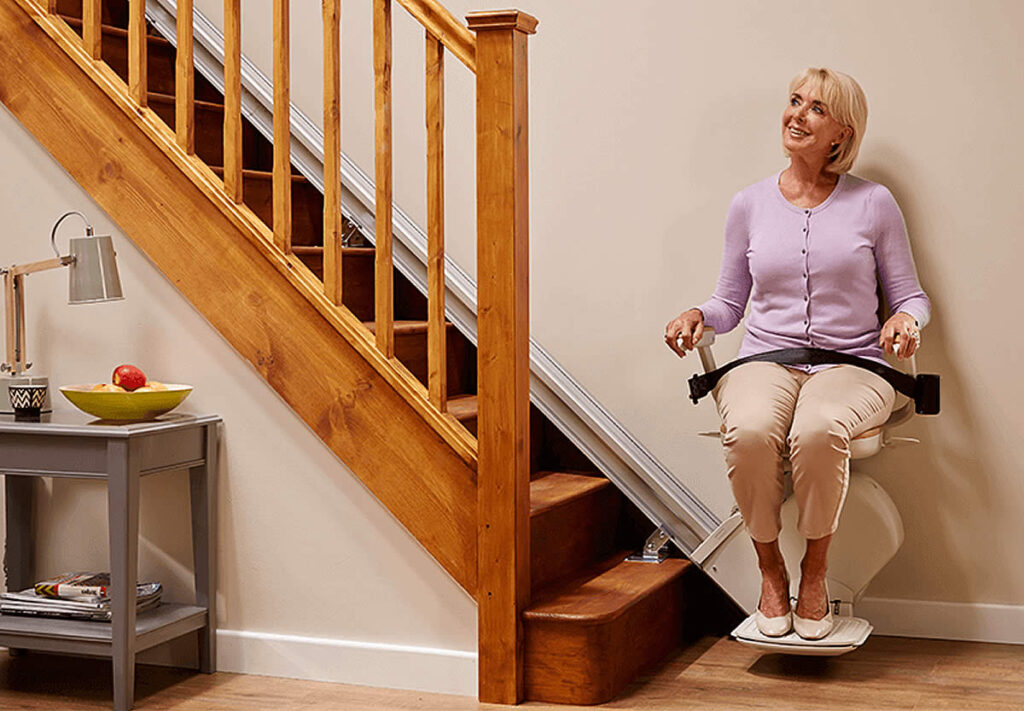 Woman using stairlift at home.