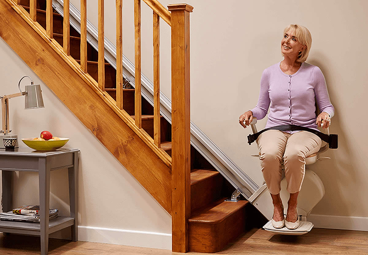 Woman using stairlift at home.