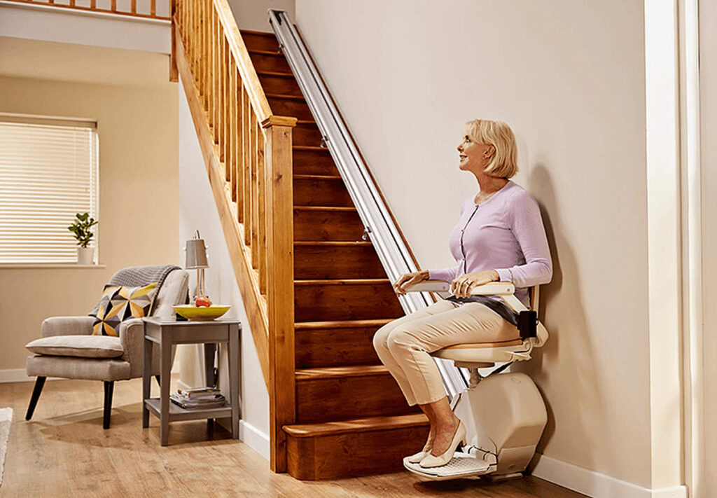 Woman using stairlift in home