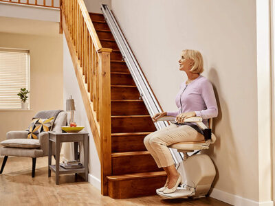 Woman using stairlift in home