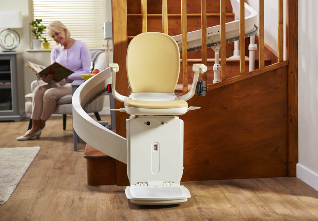Stairlift with user reading nearby.